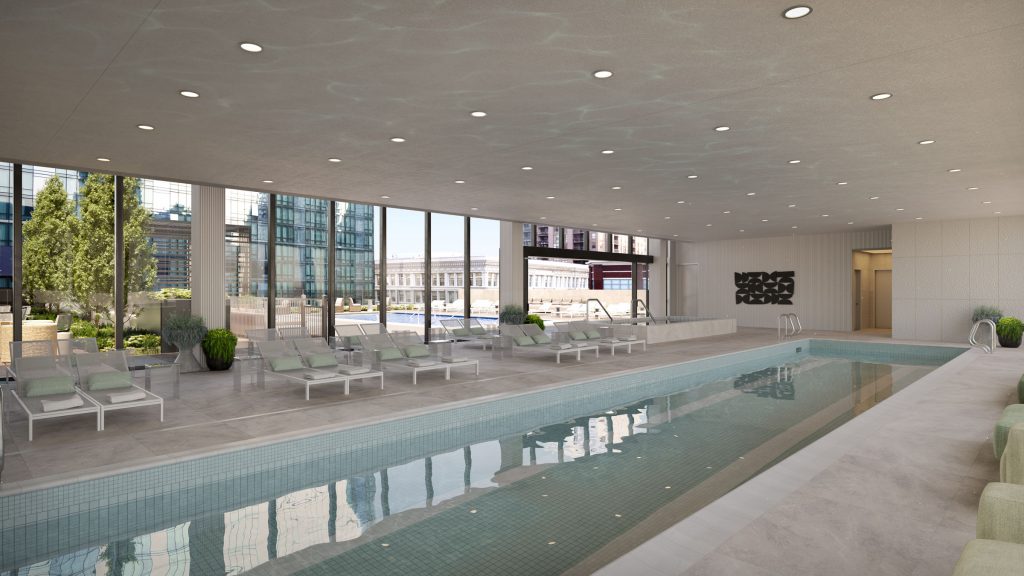 Indoor lap pool with lounge chairs and white finishes